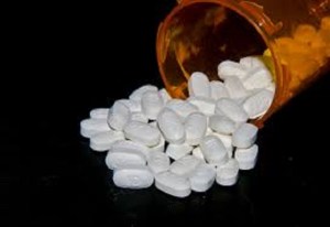 image of pills falling out of a bottle