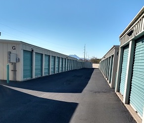 paved path through two rows of storage units